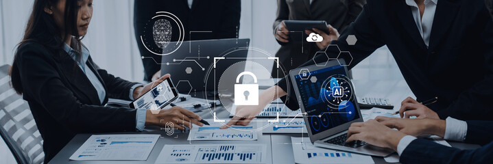 A focused business meeting on cybersecurity strategy showcases team collaboration with digital dashboards, emphasizing security and data protection in a modern office setting. Trope