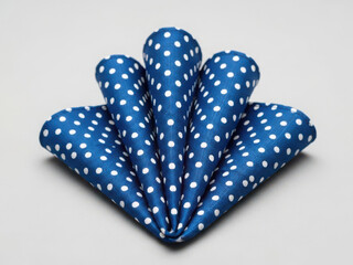 Polka dot blue napkin folded into fan shape