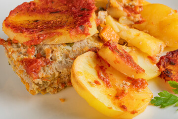 Traditional Greek moussaka slice with minced meat and potato layers.