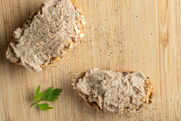Rustic multigrain bread slice topped with fish spread.