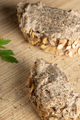 Rustic multigrain bread slice topped with fish spread.