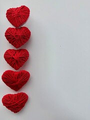 Red hearts Valentine&rsquo;s Day decoration on a light background. Romantic holiday concept symbolizing love, romance, and affection. Ideal for greeting cards, invitations, social media, advertising, brandi