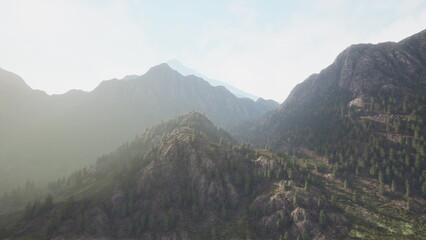 Fototapeta premium High peaks rise majestically in this serene mountain landscape. Lush greenery clings to the slopes while gentle sunlight filters through, creating a tranquil and captivating scene.