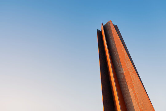 29 November 2025, Doha, Qatar: Iconic 7 sculpture by Richard Serra, a monumental steel installation, standing outdoors against a clear blue sky