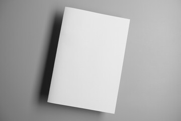Blank open white book template on a white background with empty paper pages and space for a business document or magazine cover design © ardesignzone