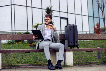 Young Businessman Reviewing Paper Report on Bench