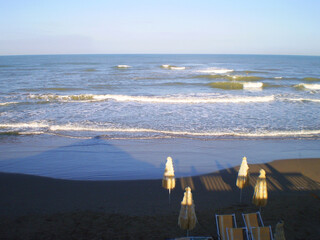 Beach and sea view at Lido dei Pini in Anzio, Italy, featuring sandy shoreline, clear blue water, and Mediterranean coastal scenery. Popular seaside destination along the Tyrrhenian Sea, known for its