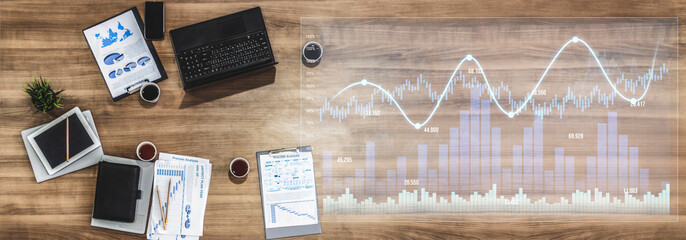 A modern office workstation featuring a laptop, business reports, and detailed graphs that illustrate data analysis and financial trends, complemented by coffee cups. Scalp