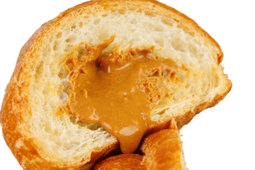 Close up of two halves of a fresh croissant with delicious caramel cream filling. Isolated on white background. Perfect for bakery advertisements, dessert menus, or food packaging design.