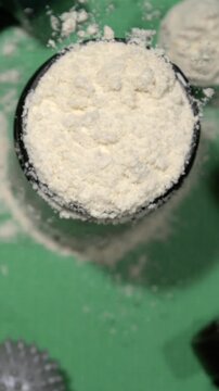 Super Slow Motion Professional Studio Photography Capturing Powdered Protein Container Alongside Gym Equipment