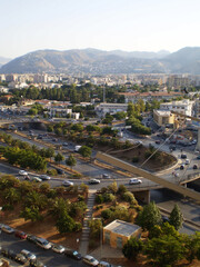 View of Palermo, Sicily, featuring beautiful roads lined with modern houses and urban development under a clear sky. Contemporary cityscape highlighting the blend of modern architecture and