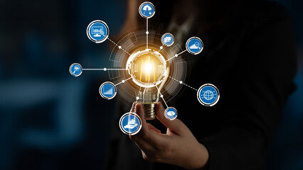 This image captures the essence of innovation with a light bulb surrounded by icons representing...