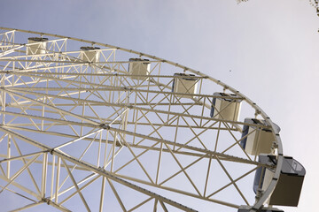 Ferris wheel in the city. A large steel structure.