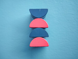 Minimalist Stack of Colorful Semicircle Wooden Blocks on Blue Background, Geometric Toy for Child Education and Balance Concept