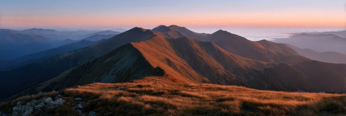 Majestic mountain range at sunrise with rolling hills and vibrant sky