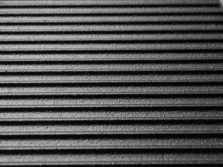 Cast iron frying pan surface with ridges for cooking meat and vegetables.