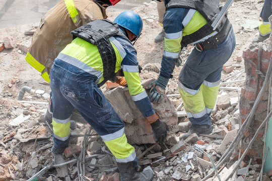 Rescue workers clearing debris at collapsed building site