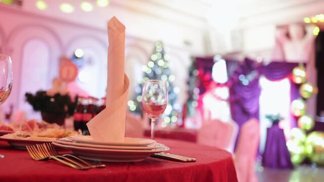 Empty Decorated Banquet Hall with Christmas Tree in the Background