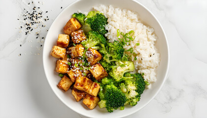 Top view of healthy tofu bowl with broccoli and rice on white background. Vegetarian food concept
