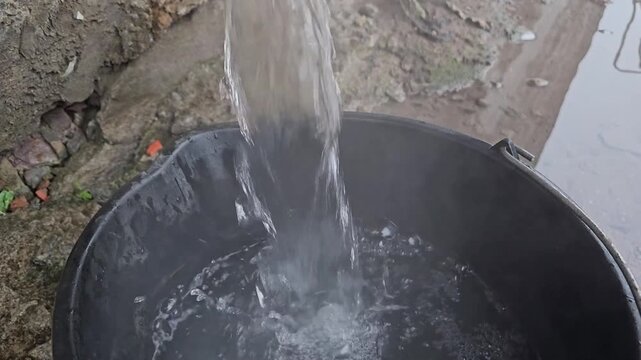 Old water tap with water leak, flow of clean water from a faulty garden watering faucet, footage for films about wasting resources, energy saving, sustainability, domestic economy, saving money ideas