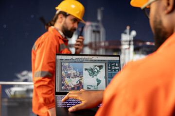 Close up of offshore platform technician uses laptop software to review geological survey data and do digital mapping. Drilling rig worker evaluates seabed topography maps for site assessment planning