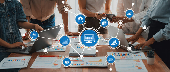 This image captures a dynamic workplace scene where professionals engage with data analysis and digital tools, fostering collaboration and innovation to drive business success. Amity