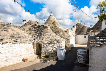 Cluster of ancient trulli under string lights, showcasing Alberobello&rsquo;s timeless charm, Apulia, Italy