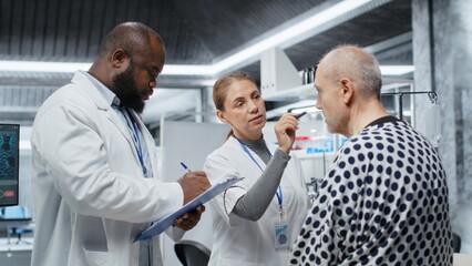 Fototapeta premium Laboratory experts analyzing a patient vitals during drug testing, evaluating treatment safety, dosage reactions and side effects in a study. Innovation and prevention in healthcare. Camera B.