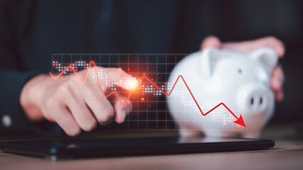 Financial planner analyzing declining savings performance using tablet with downward chart and piggy bank. Concept of financial risk, savings loss, economic downturn, personal finance challenge