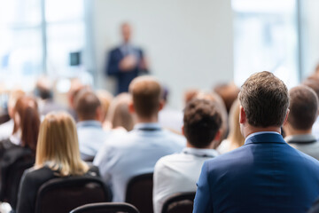 Business and entrepreneurship symposium. Speaker giving a talk at business meeting. Audience in the conference hall