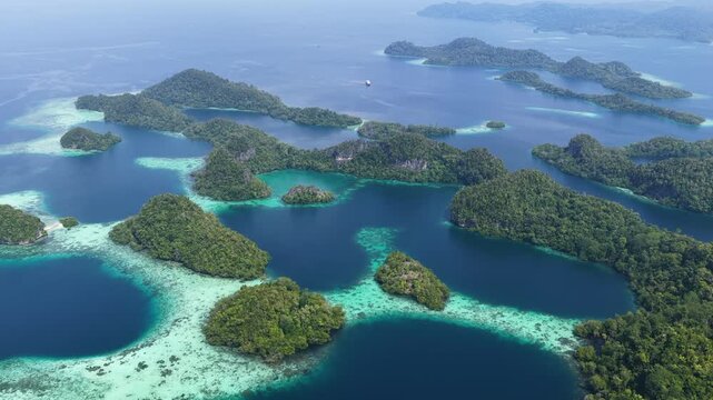 Shallow coral reefs fringe the beautiful islands of Pef, Raja Ampat, Indonesia. This region harbors spectacular marine biological diversity and is a popular destination for divers and snorkelers.
