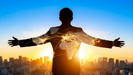 夕暮れの街を見下ろし、両手を広げるビジネスマンの多重露光です。きらきらと輝く世界地図のネットワークが重なり、世界への進出と未来への希望を表現しています。グローバルな事業展開や海外進出、通信テクノロジーの発展を伝える広告に最適な、壮大なビジョンを感じさせる一枚です。