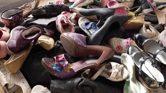 Fast fashion waste pile of worn shoes