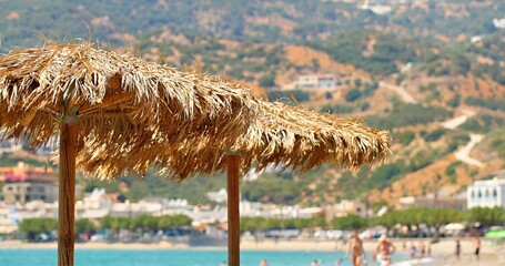 Relaxing Coastal Scene With Parasol, Tranquil Beachfront Setting With Vibrant Sky And Distant Resorts