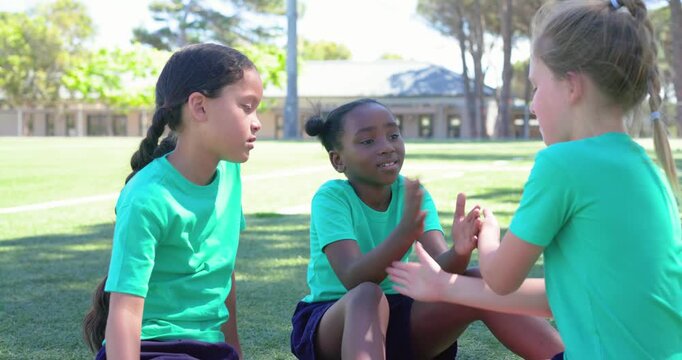 African American girls clapping at school right starting center returning left joining at recess