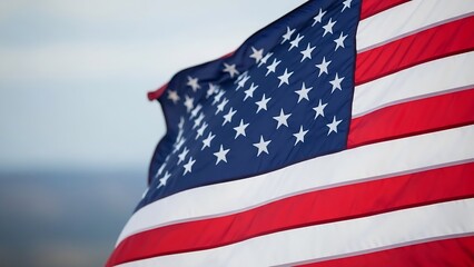 American flag waving in the wind against a cloudy sky