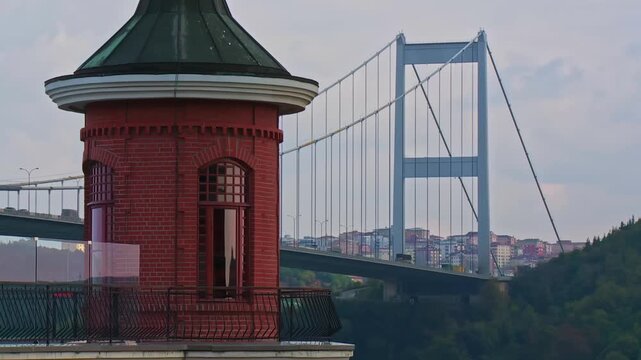 Fatih Sultan Mehmet Bridge Pillar with Traffic and Perili Kosk Tower Roof in the Foreground