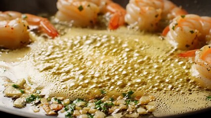 Delicious succulent shrimp sizzling and bubbling in a hot pan with melted butter aromatic garlic and fresh herbs creating a mouthwatering culinary experience perfect for a gourmet meal preparation.