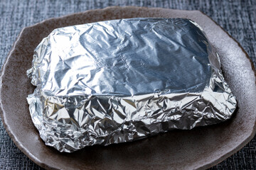 ローストビーフ調理シーン。アルミホイルで包んで保温している。