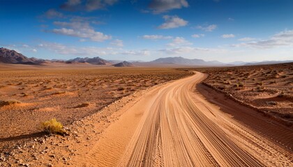 A Dusty Road Winding Through A Vast Barren Desert