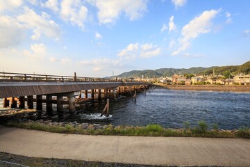 Fototapeta premium Long Traditional Wooden Uji Bridge Spanning the River at Golden Hour