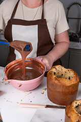 Confectioner checking the correct texture of the melted chocolate_vertical.