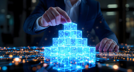 Businessman building virtual cityscape with glowing blue cubes in modern office