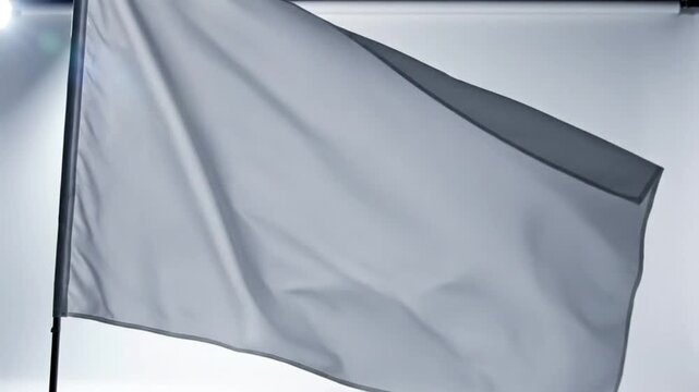 Waving white flag representing surrender, truce, or peace against a bright background with subtle wind