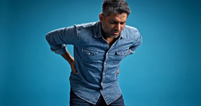 Man with back pain standing.