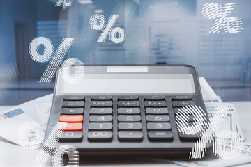 Calculator placed on a pile of Euro and US Dollar money. Concept overlaid with white percentage symbols, for inflation, tax calculation, loan rates and financial analysis in business context.