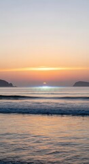 Fototapeta premium Distant sun illuminates horizon above rolling ocean waves near dark landmasses