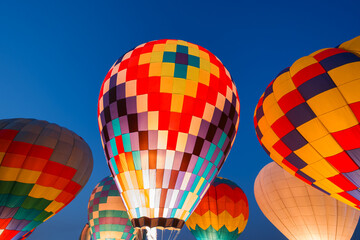 colorful hot air balloons glowing against sky
