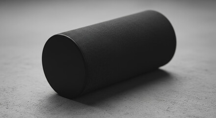 Modern Black Cylindrical Wireless Speaker on Concrete Surface, Minimalist Audio Technology Product Shot
