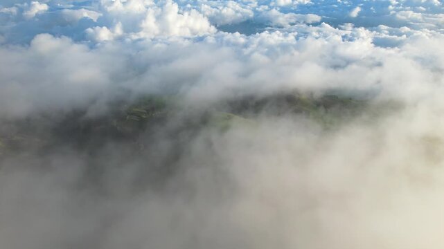 Aerial Drone Video of Rural Farmland and Green Hills Under Cloudy Sky